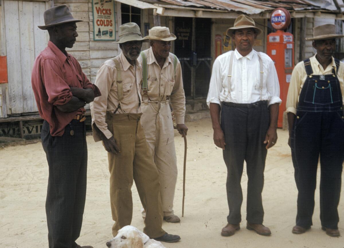 In this 1950s photo, men included in a syphilis study pose for a photo in Tuskegee, Ala. 