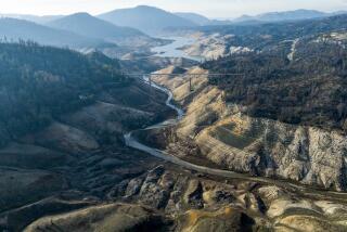 An image taken with a drone shows low water conditions at Enterprise Bridge located at Lake Oroville. 