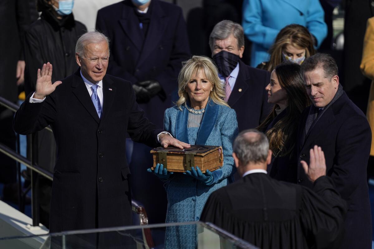 Joe Biden takes the oath of office from Chief Justice John G. Roberts Jr. as his wife Jill holds the Bible on Wednesday