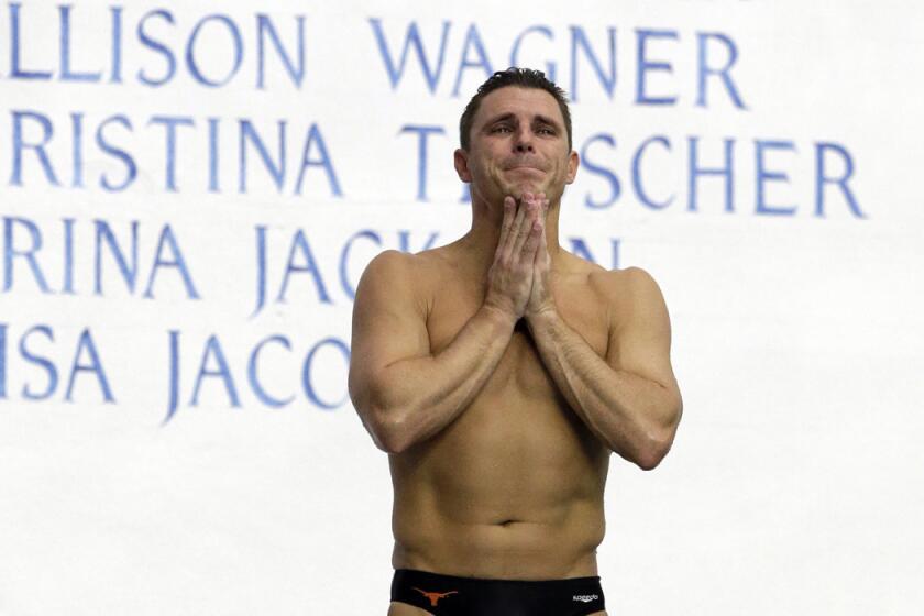 Troy Dumais reacts to the crowd as he waits to performs his final dive during the men's 3-meter springboard final at the U.S. Olympic diving trials on Saturday.
