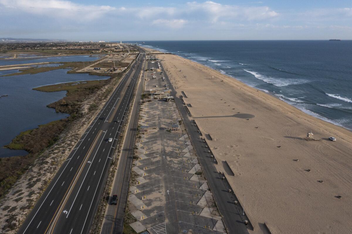 An aerial view shows Bolsa Chica State Beach campground, uncharacteristically empty on a spring day during a pandemic closure, 2021.