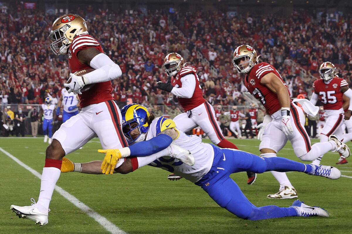 San Francisco's Jimmie Ward returns an intercepted pass intended for the Rams'  Tyler Higbee (89) for a touchdown.