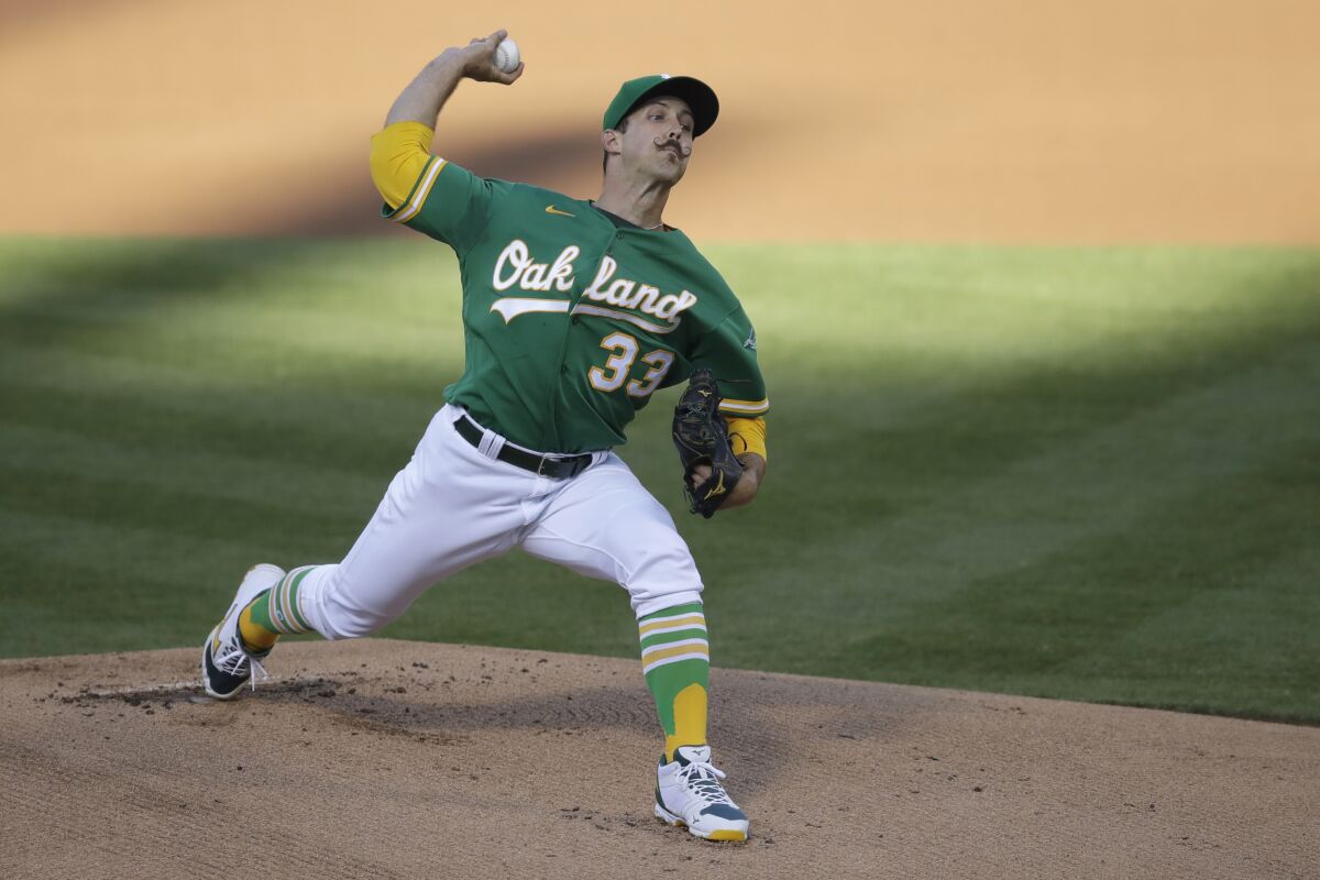 Oakland Athletics pitcher Daniel Mengden works against the Colorado Rockies in the first inning of a baseball game Tuesday, July 28, 2020, in Oakland, Calif. (AP Photo/Ben Margot)