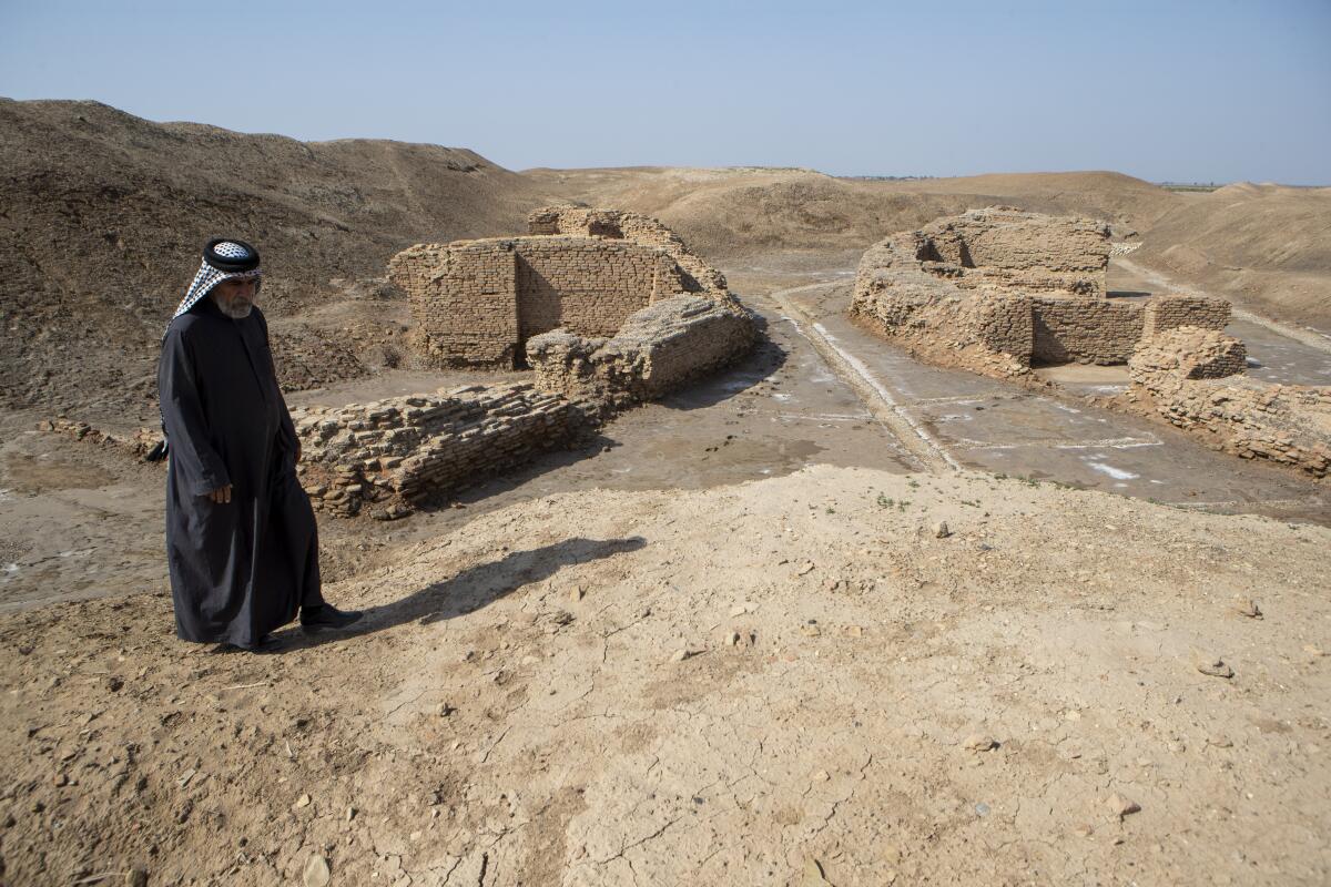Man standing by an archaeological excavation