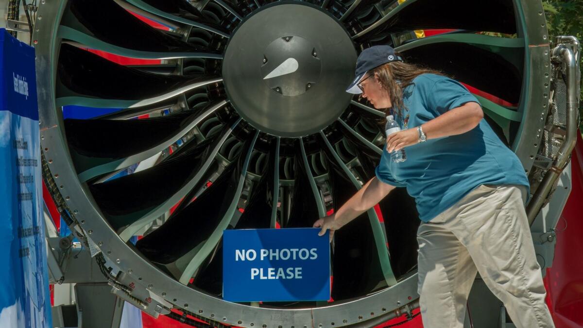 A Pratt & Whitney employee with the company's latest Geared Turbofan engine, seen on display in Washington, D.C. earlier this year.