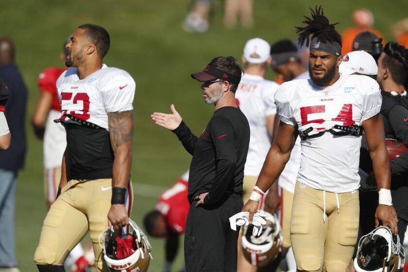 San Francisco 49ers quarterbacks coach Shane Day, center, directs players.