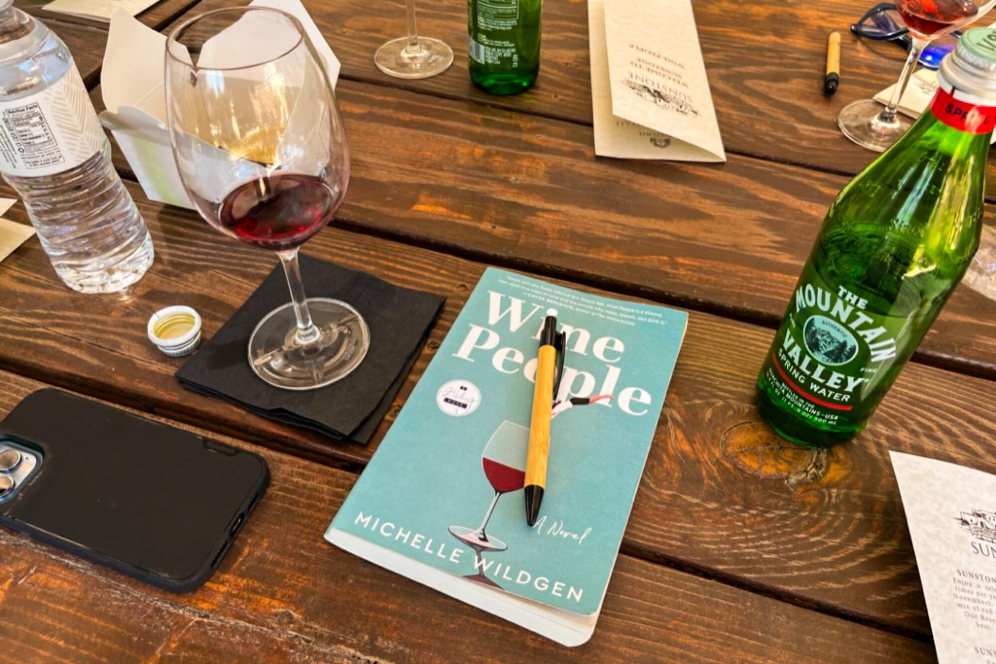 A book and glass of wine. 