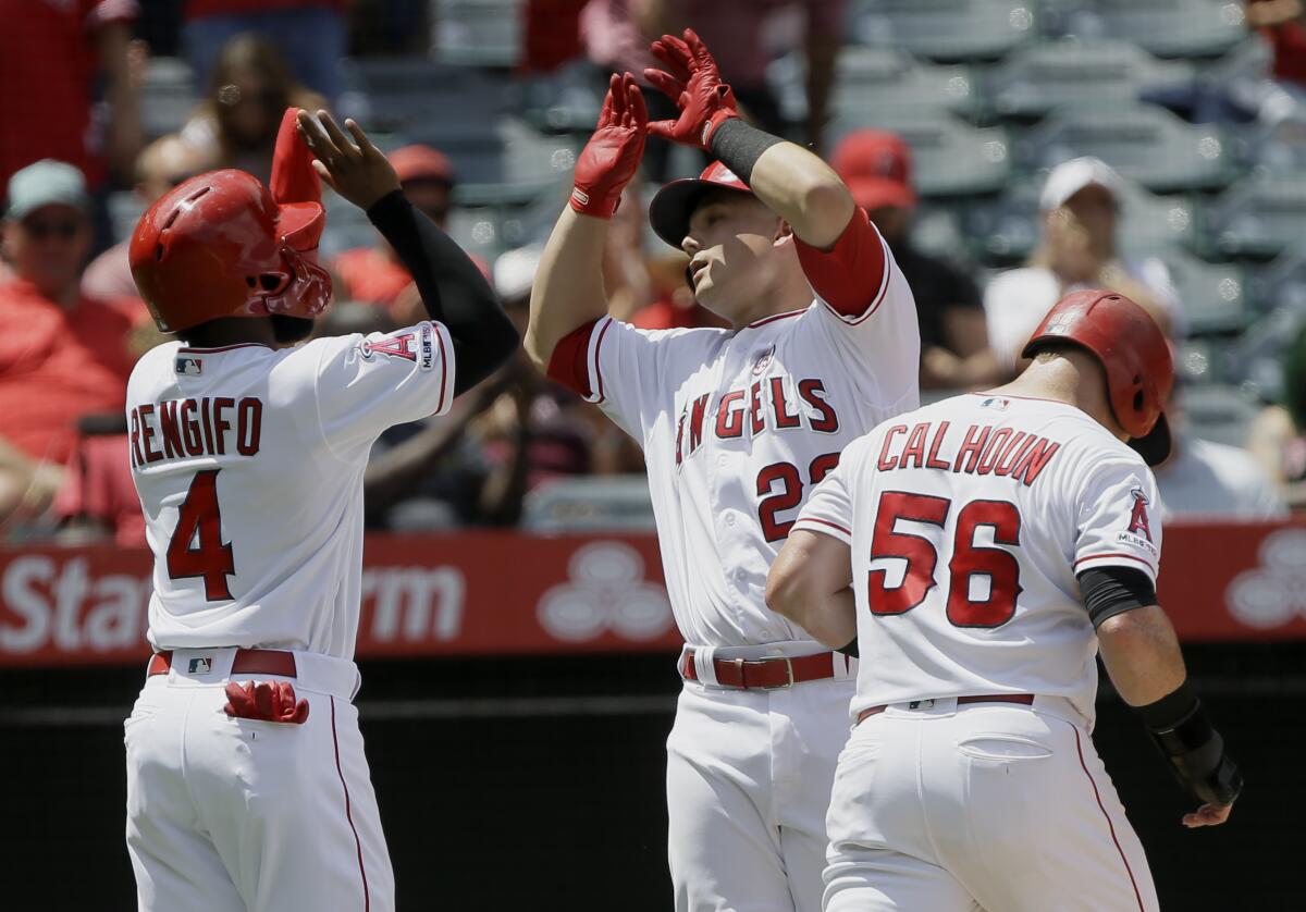 The Angels' Matt Thaiss is congratulated by teammates Luis Rengifo and Kole Calhoun after hitting a three-run homer against the White Sox on Sunday.