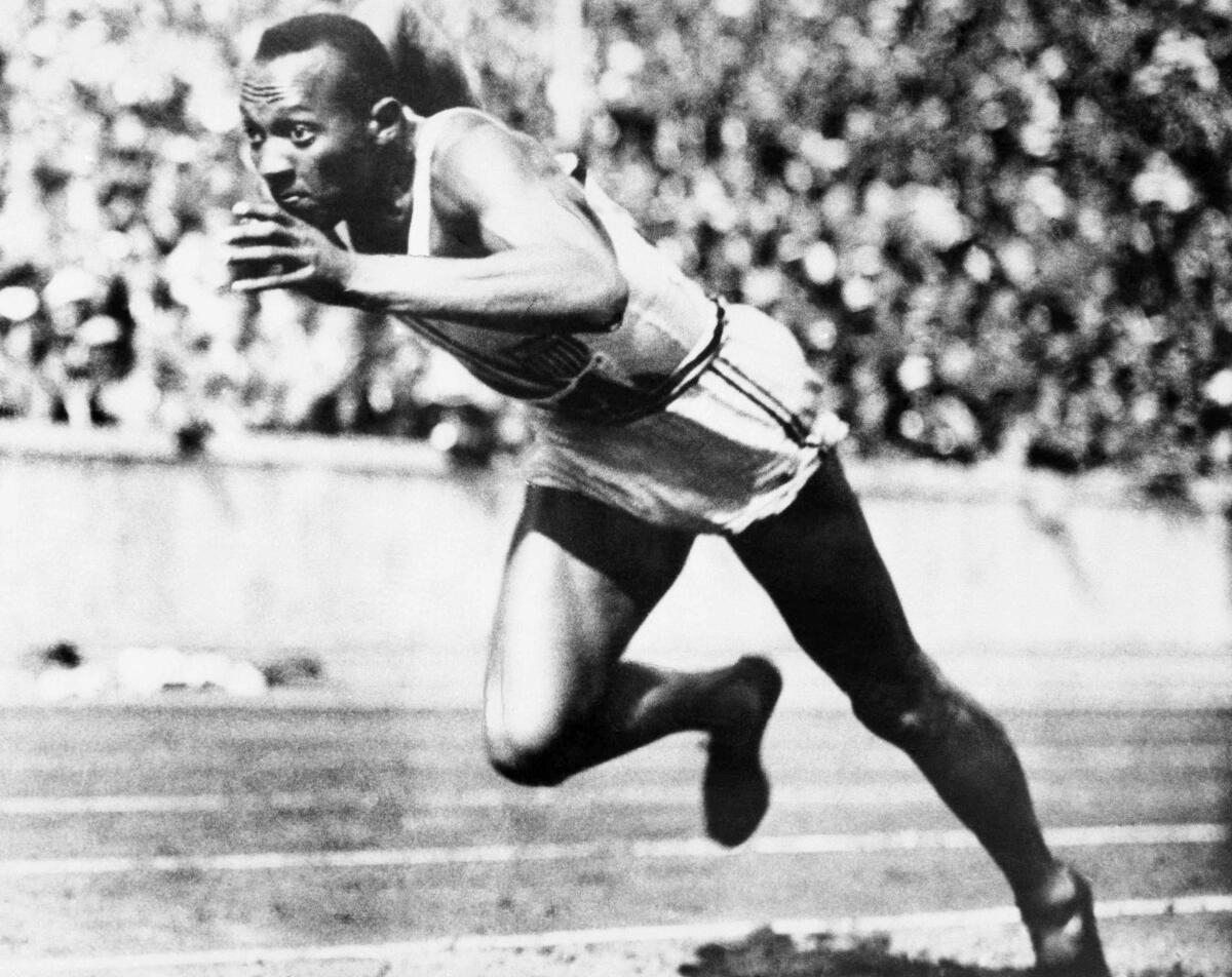Jesse Owens competes in the 1936 Olympic Games in Berlin.