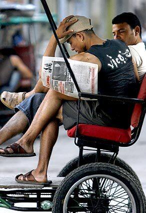 A man reads the latest edition of Cuba's Granma newspaper in Havana.