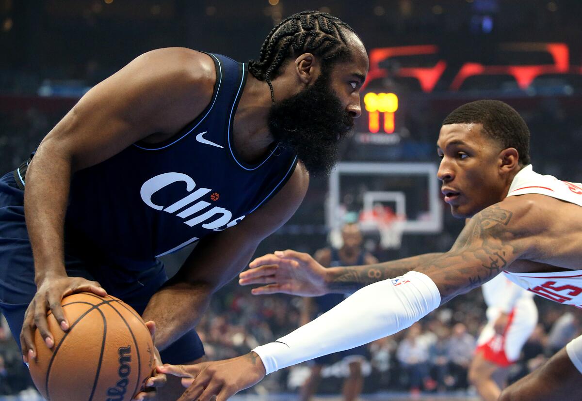 Clippers guard James Harden, left, controls the ball in front of Houston Rockets forward Jabari Smith Jr.