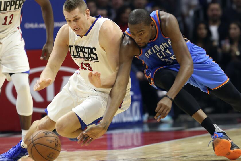 Clippers center Cole Aldrich and Thunder forward Kevin Durant go after a loose ball during the first quarter on Dec. 21.