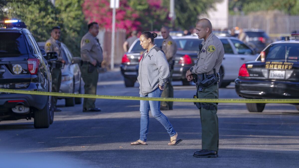 Maria Reza, who said she is the mother of a man fatally shot by Los Angeles County sheriff’s deputies Thursday morning, walks in the street at the scene in Pico Rivera.