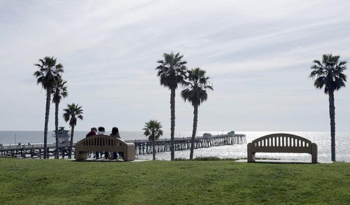 Visitors take in a shimmering view of the water off San Clemente and the 1,200-foot-long pier, a popular hangout.