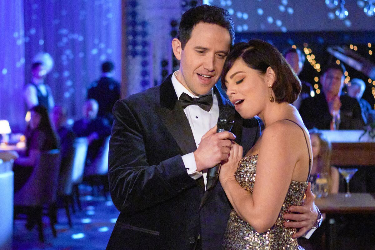 A man in a tuxedo dances with a woman in a sparkly dress