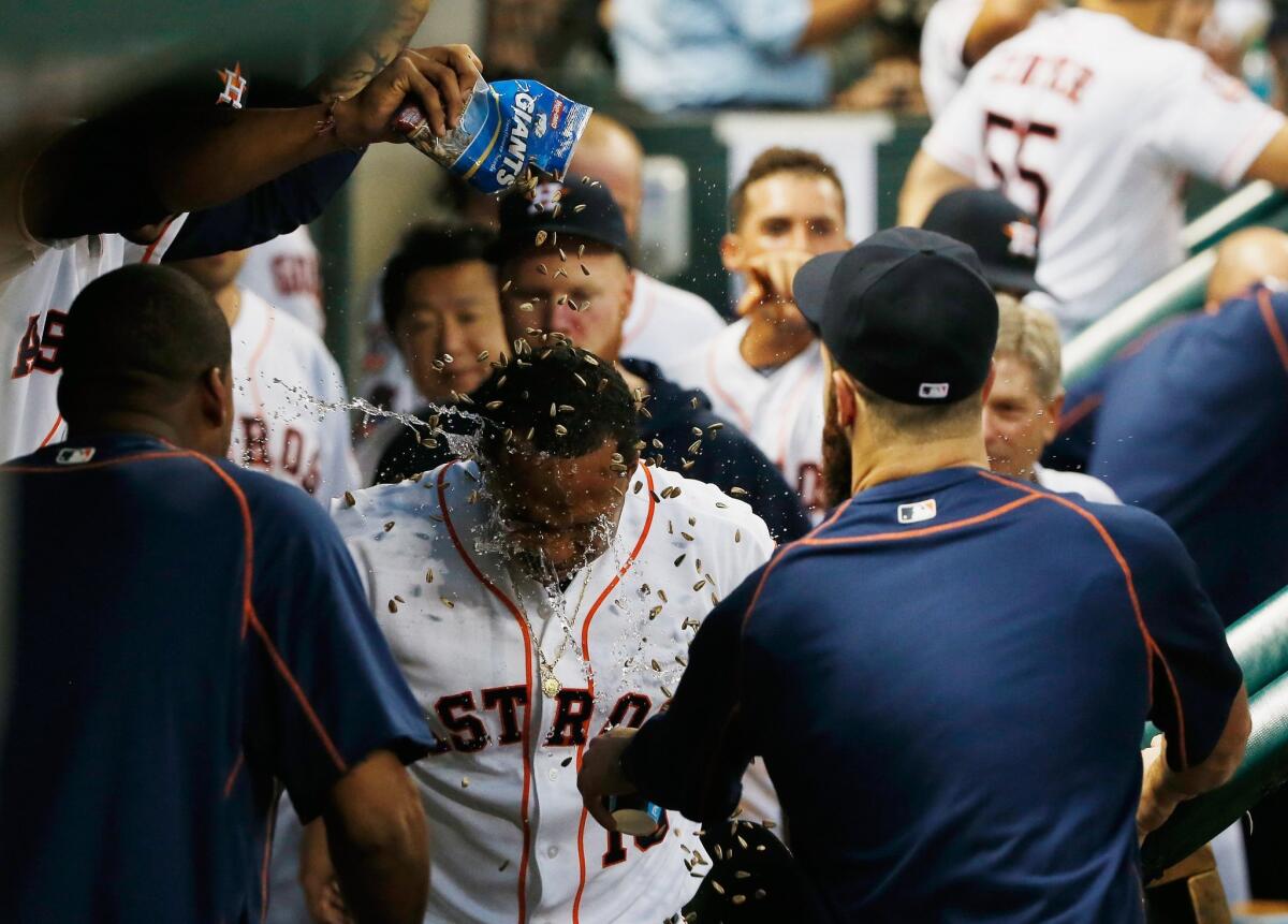 Houston's Luis Valbuena gets showered with water and sunflower seeds after hitting a home run against Baltimore on June 2.