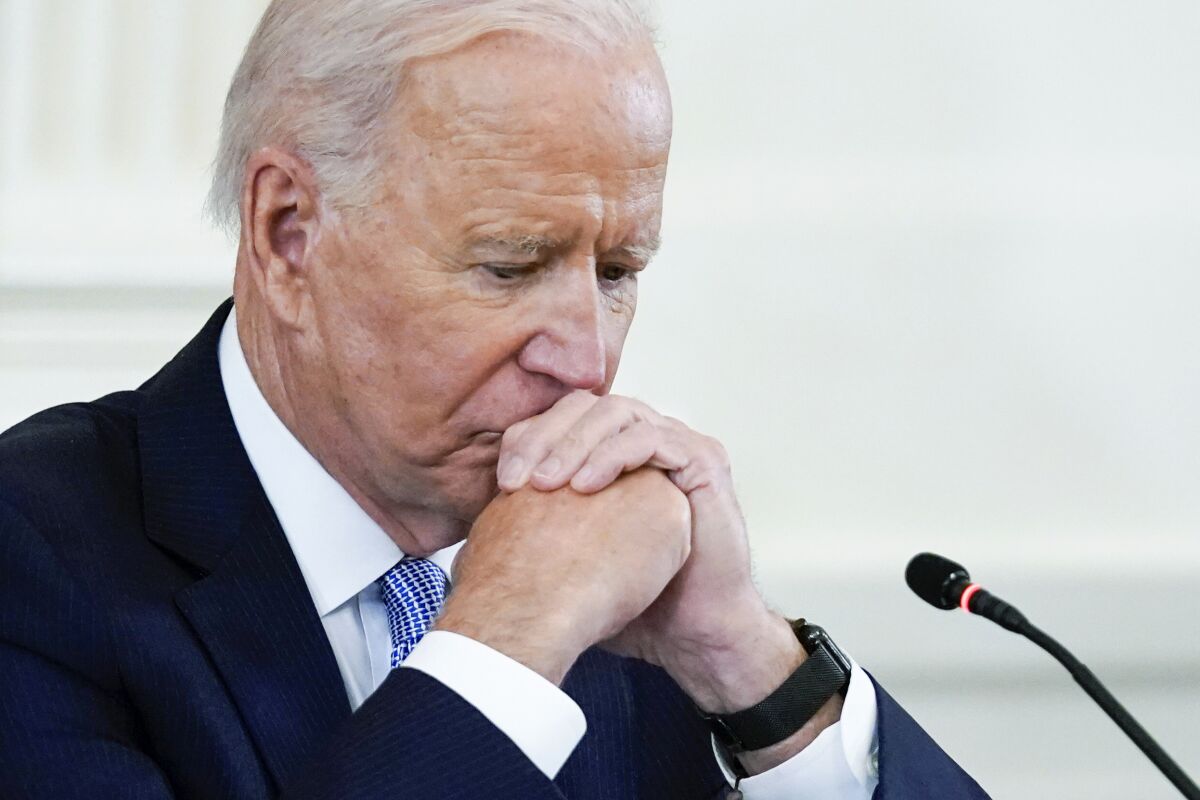 In this Sept. 24, 2021 photo, President Joe Biden listens during the Quad summit in the East Room of the White House. President Joe Biden's popularity has slumped — with half of Americans now approving and half disapproving of his leadership. That's according to a new poll by The Associated Press-NORC Center for Public Affairs Research. (AP Photo/Evan Vucci)
