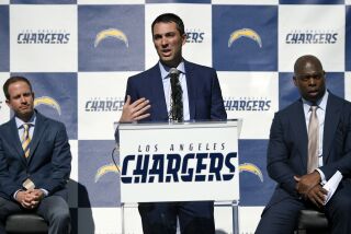 Los Angeles Chargers general manager Tom Telesco, center, introduces Anthony Lynn, right, as the team's new head coach, as president of football operations John Spanos looks on during an NFL football news conference in Carson, Calif., Tuesday, Jan. 17, 2017. (AP Photo/Kelvin Kuo)