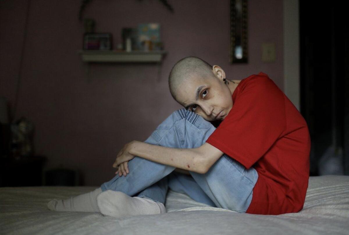 Chalise Scholl (cq), 37, poses for a photograph in her home bedroom Thursday, May 30, 2019, in Peoria. Scholl was diagnosed with stage 4 cervical cancer in December of 2018, which spread to her liver, and has gone through three rounds of chemotherapy, with a possible fourth round to come in June. She is raising funds for her burial costs through the sale of cancer awareness bracelets, in addition to a GoFunMe page, with a goal of $2,500. (John J. Kim/Chicago Tribune)