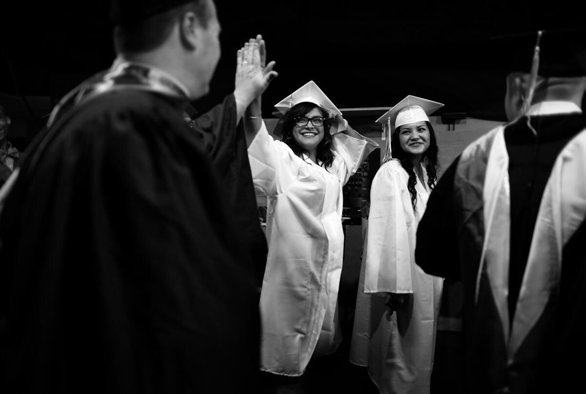 Stephanie high fives her Camp Scott math teacher, Charlie Phelps, before heading on stage at the Walt Disney Concert Hall in Los Angeles to receive her High School diploma.