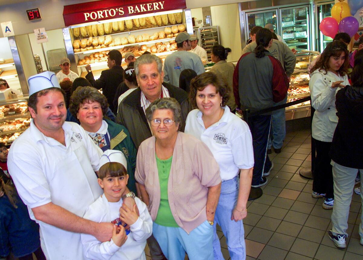 Raul Porto Sr. stands among three generations of the Porto family in their bakery in 2001.