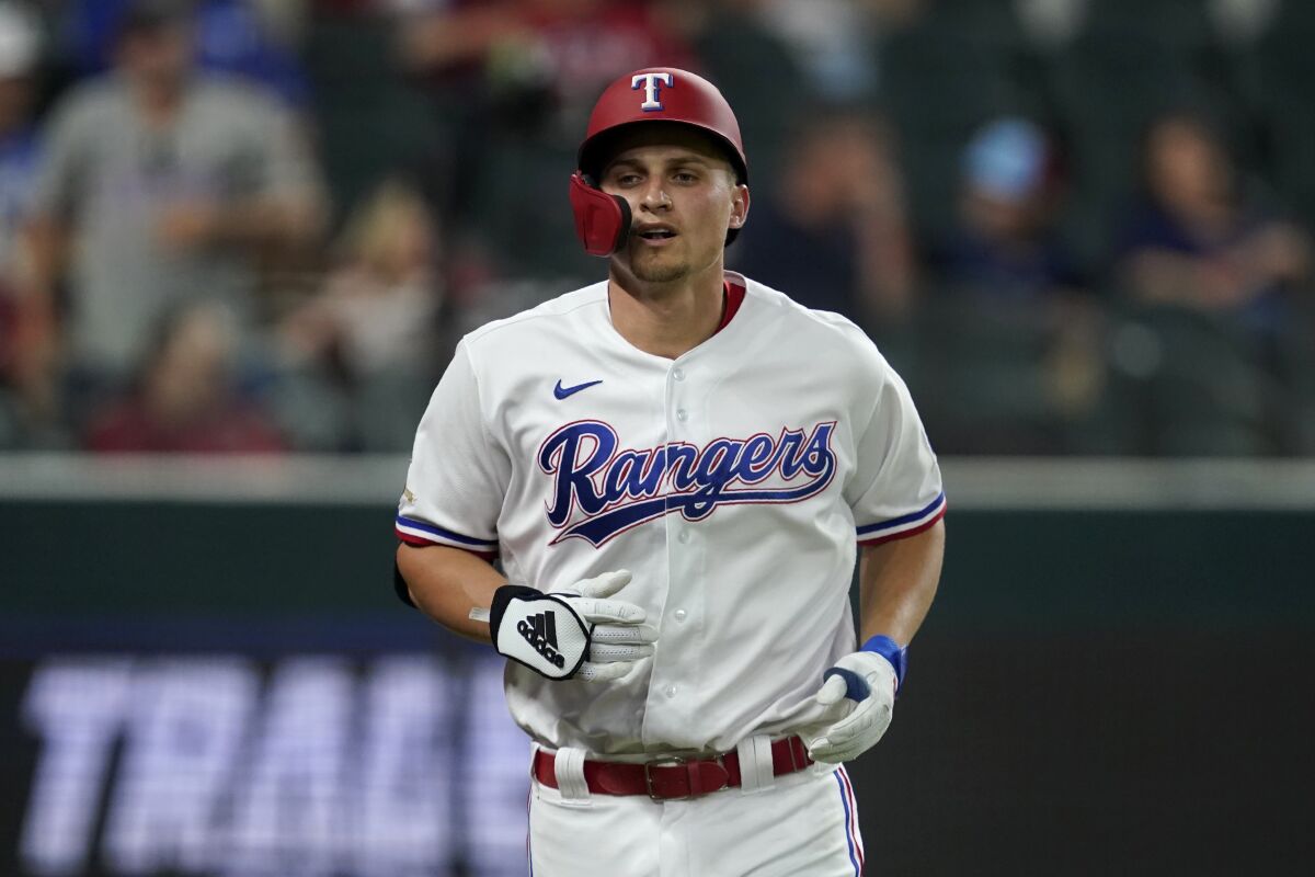 Texas Rangers' Corey Seager jogs to the dugout after hitting a solo home run in the third inning of a baseball game against the Kansas City Royals, Tuesday, May 10, 2022, in Arlington, Texas. (AP Photo/Tony Gutierrez)
