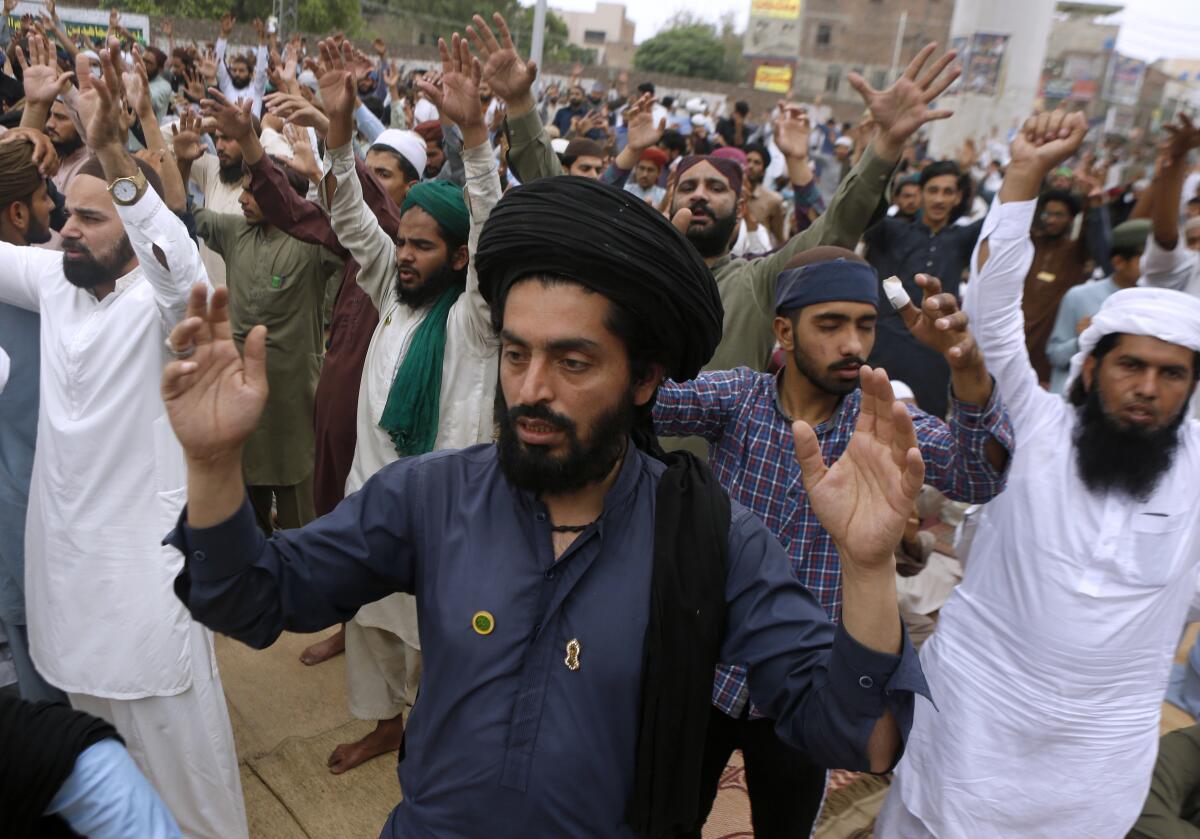 Supporters of Tehreek-e-Labiak Pakistan, a radical Islamist political party, chant slogans during a sit-in protest against the arrest of their party leader Saad Rizvi and demanding to expel the French envoy from the country, in Lahore, Pakistan, Friday, April 16, 2021. Pakistan briefly blocked access to all social media on Friday, after days of anti-French protests across the country by radical Islamists opposed to cartoons they consider blasphemous. (AP Photo/K.M. Chaudary)