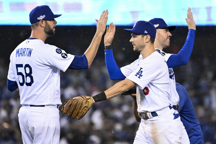 Los Angeles, CA - October 11: Los Angeles Dodgers relief pitcher Chris Martin, left, celebrates with Trea Turner.