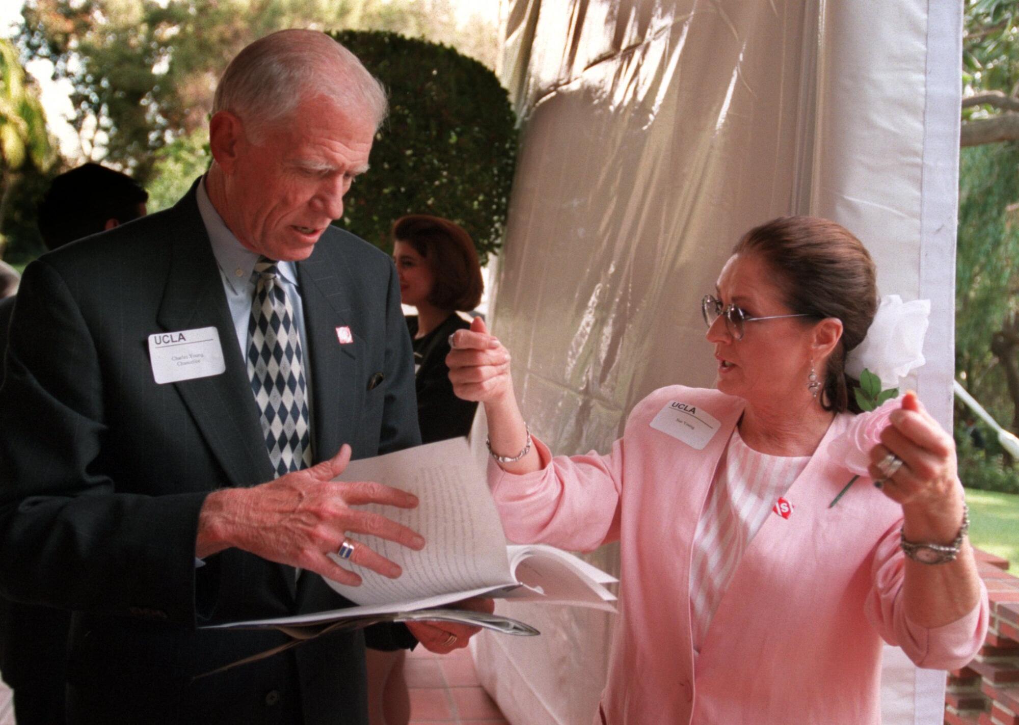 UCLA Chancellor Charles E. Young goes over his notes as his wife, Sue.