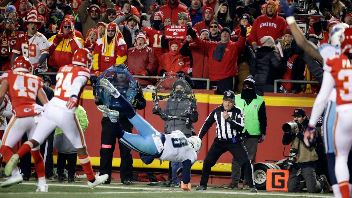 Tennessee Titans quarterback Marcus Mariota (8) leaps for a touchdown in front of Kansas City Chiefs defensive back Will Redmond (24) during the second half.