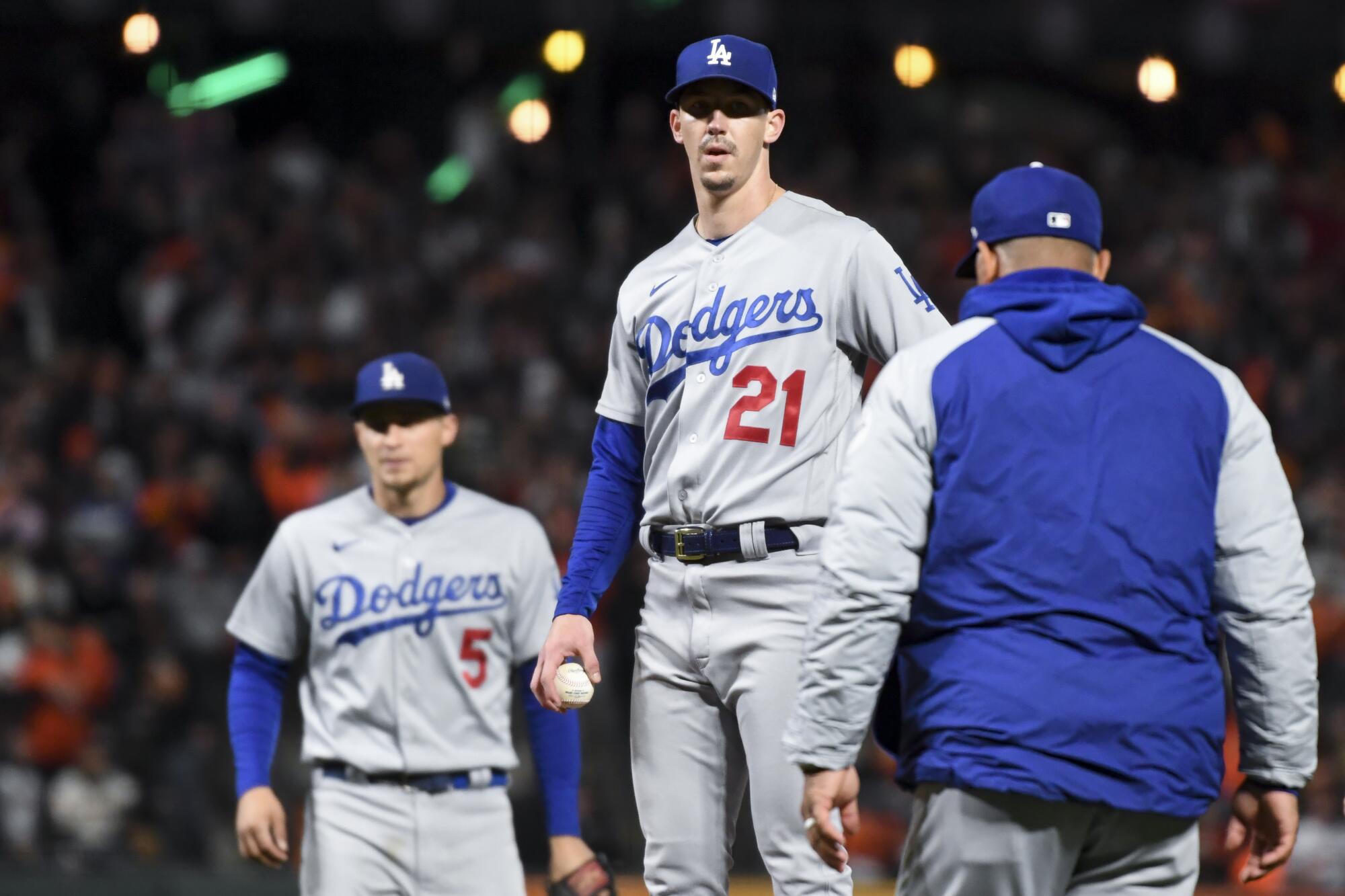 Los Angeles Dodgers manager Dave Roberts, right, goes to the mound to remove Walker Buehler