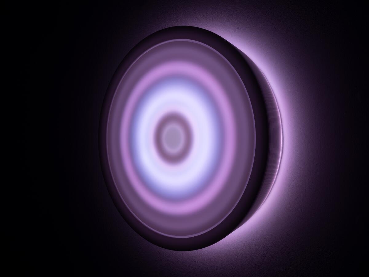 Concentric circles glow in shades of purple.