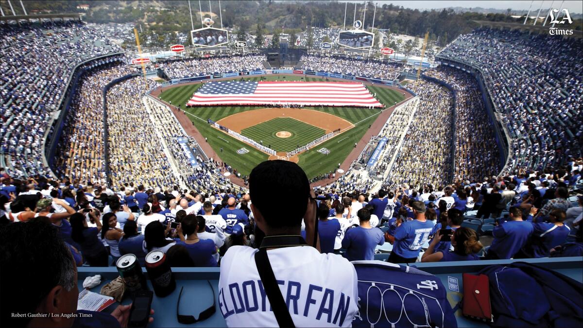 A fan looks on during the pregame ceremony at Dodger Stadium.