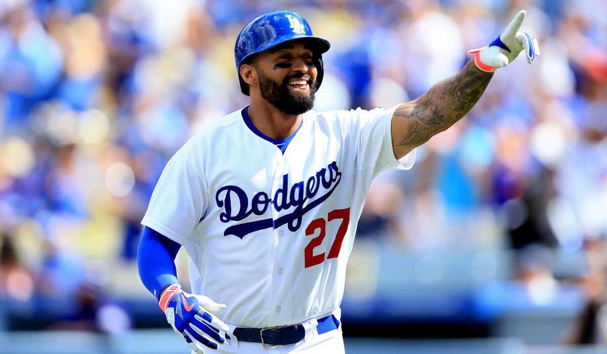 Dodgers right fielder Matt Kemp points to the stands after hitting a home run against the Rockies in the first inning Sunday.