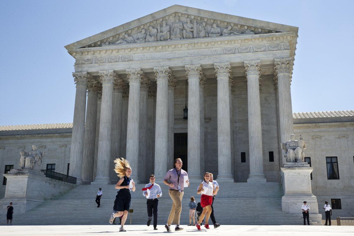 New interns run with a decision across the plaza of the Supreme Court in Washington, Monday June 29, 2015. (AP Photo/Jacquelyn Martin) The Associated Press