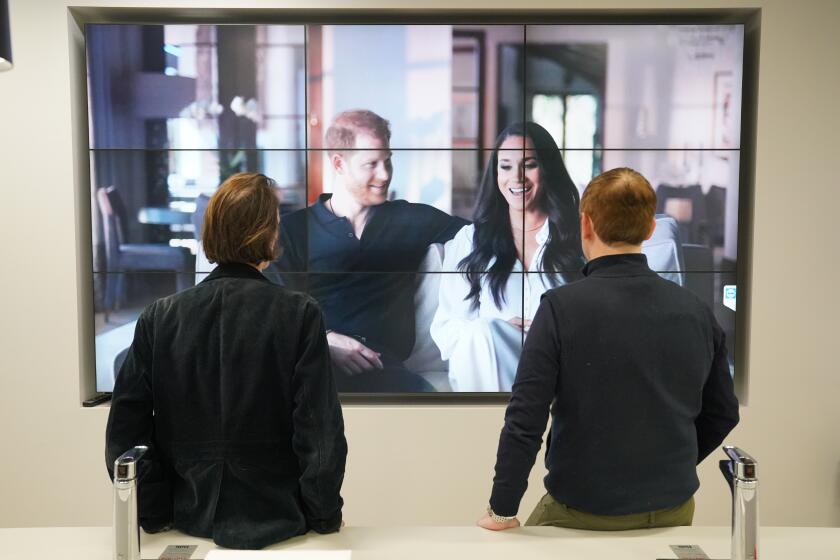 Office workers in London, watching the Duke and Duchess of Sussex's controversial documentary being aired on Netflix. Harry & Meghan - a six-part docuseries - dropped on the streaming giant at 8am in the UK on Thursday, with the royal family steeling themselves for the revelations in the first three episodes. Picture date: Thursday December 8, 2022. (Photo by Jonathan Brady/PA Images via Getty Images)