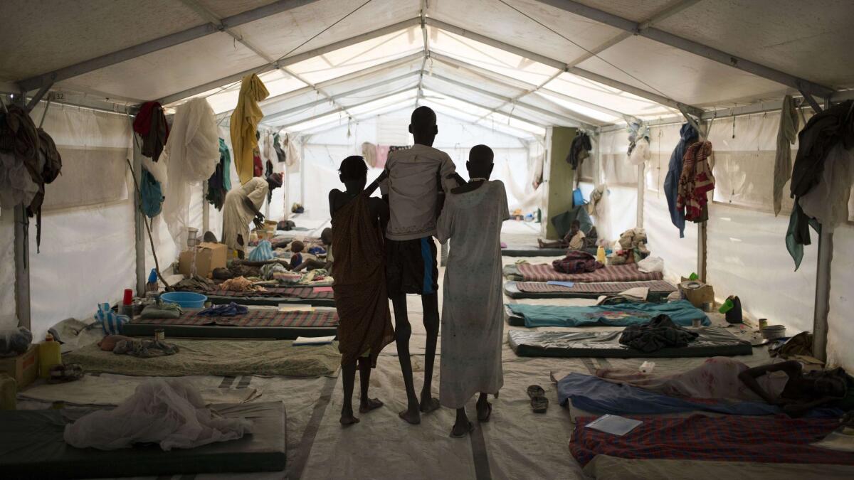 A 2015 photo from Doctors Without Borders shows a man suffering visceral leishmaniasis, also known as kala-azar, black fever and dumdum fever, being helped by his wife, right, and a relative at one of the agency’s hospitals in South Sudan.