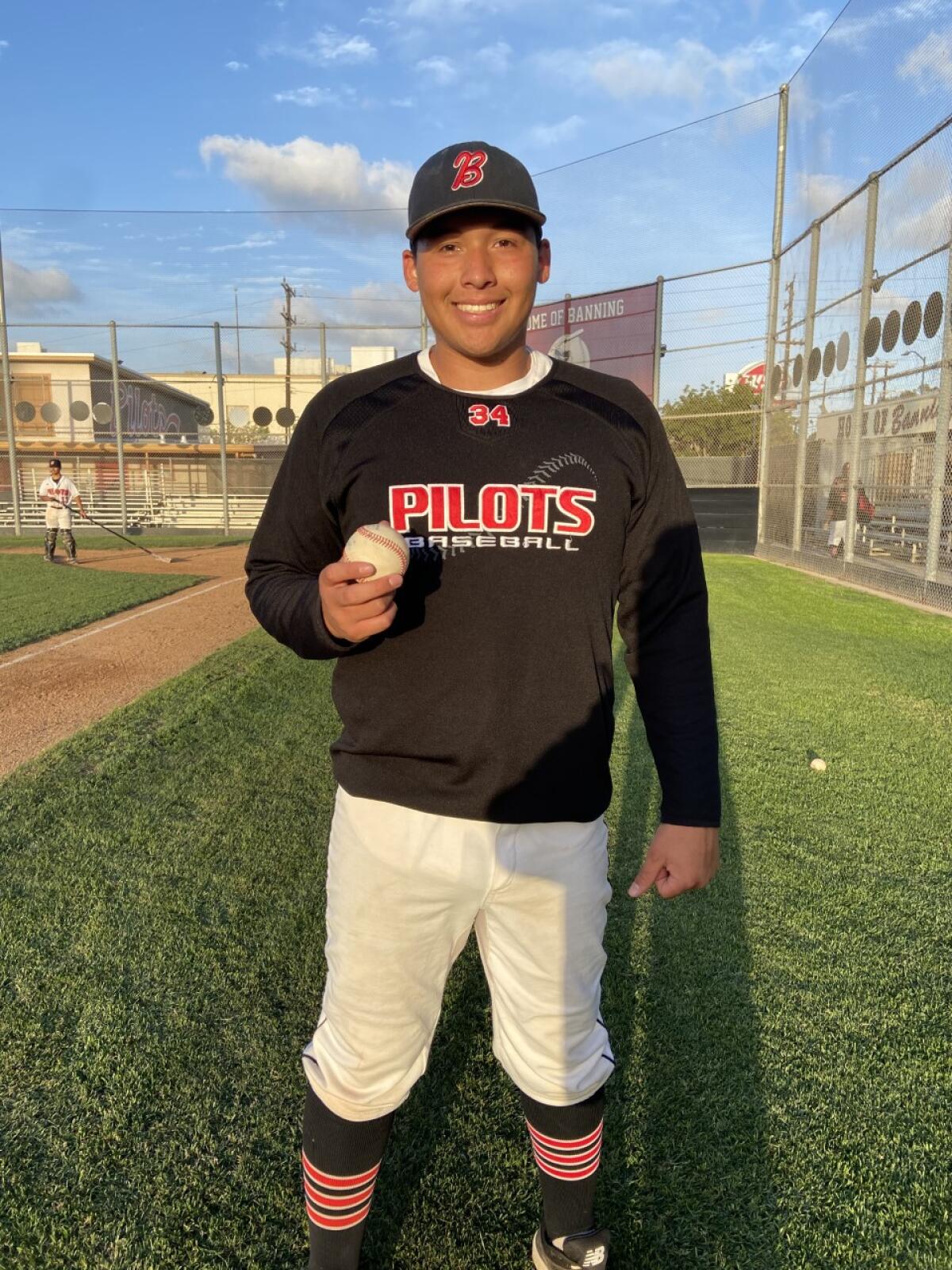 Anthony Joya of Banning shows off baseball after throwing no-hitter against Sun Valley Poly. He struck out 15.