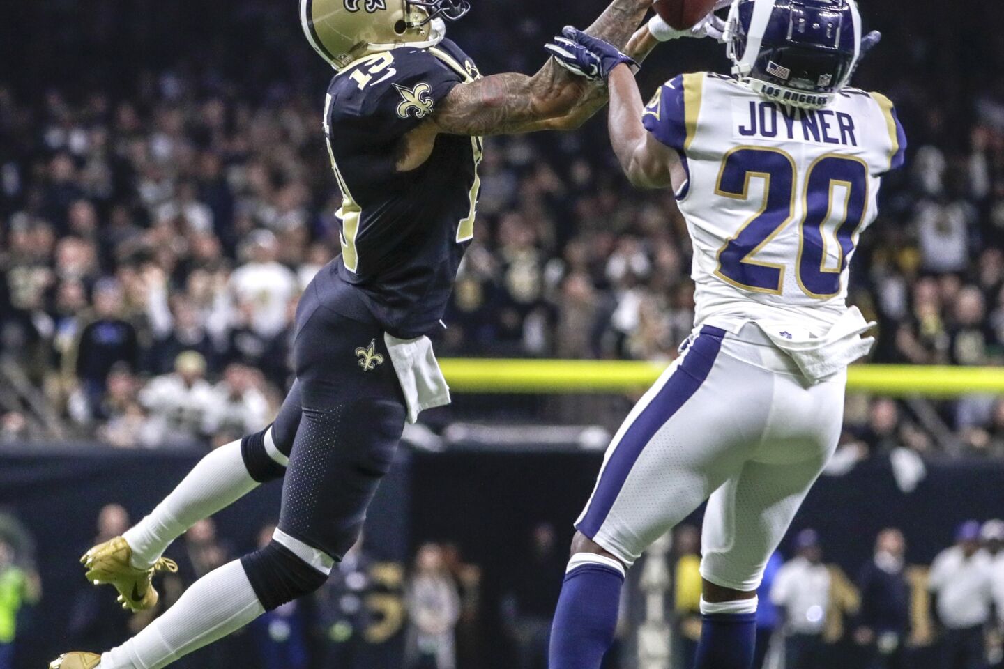 New Orleans Saints receiver Ted Ginn Jr. pulls down a 43-yard pass in front of Rams safety Lamarcus Joyner late in the fourth quarter in the NFC Championship at the Superdome.