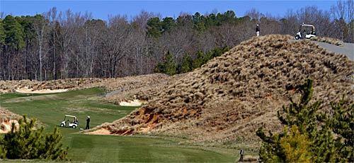 A golfer pauses atop a hill to watch the play below him on the first hole at Tobacco Road. Strantz was a master illusionist. Take the tee shot here. It looks intimidating, but it really isn't.