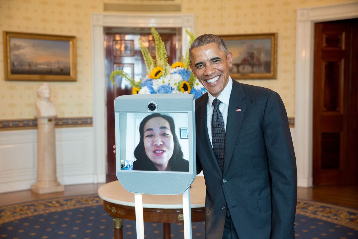 President Obama greets Alice Wong, Disability Visibility Project founder, via robot.