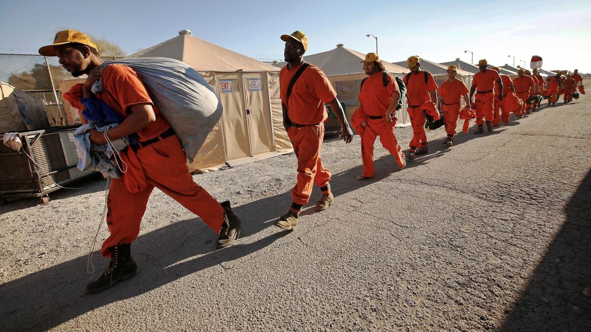 Inmates working on the Thomas fire crew rest at camp between shifts on the fire line.
