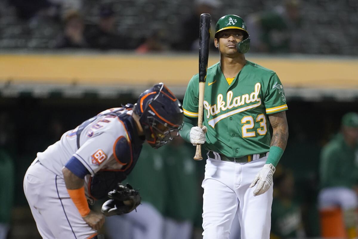 Oakland Athletics' Christian Bethancourt (23) reacts after striking out next to Houston Astros catcher Martin Maldonado for the final out of a baseball game in Oakland, Calif., Friday, July 8, 2022. (AP Photo/Jeff Chiu)
