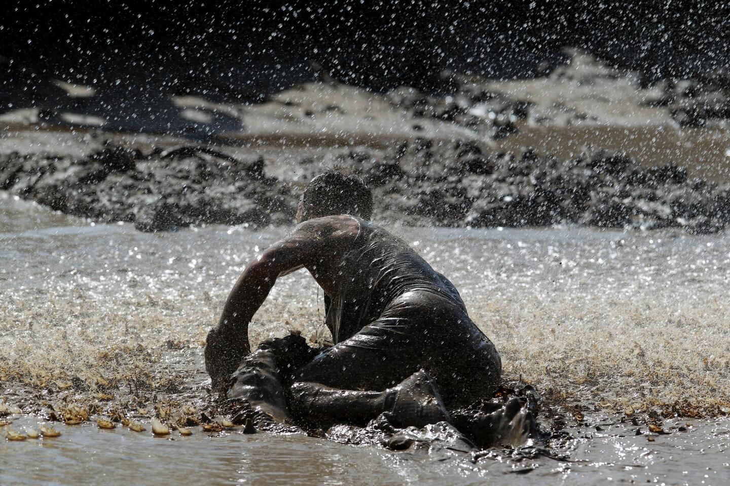 A runner finds himself on his hands and knees during the 21st annual World Famous Mud Run at Camp Pendleton.