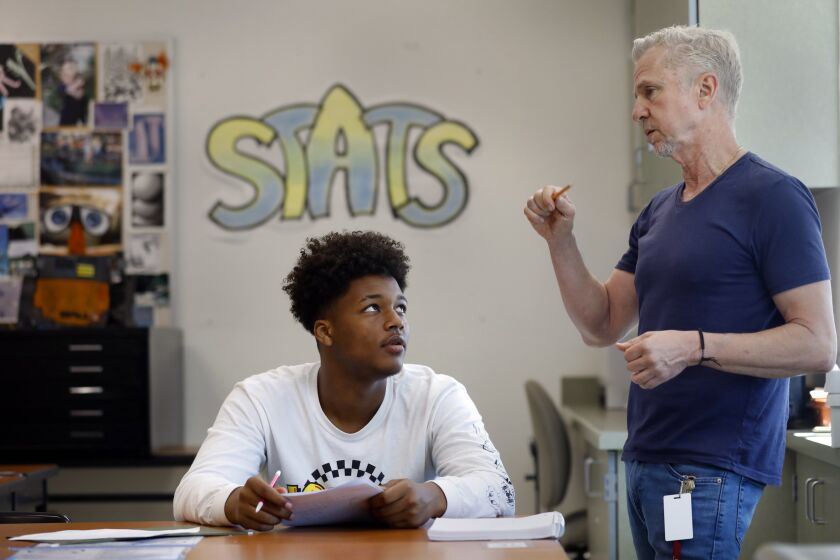 LOS ANGELES, CALIFORNIA--AUG. 29, 2019--At Roybal Learning Center in Los Angeles, Robert Montgomery, right, teaches a "transition to college math and statistics" class to 12th graders. One of his students is Robert Moore, age 17, left, who says he plans to go to college. The course, developed in partnership with the CSU, includes review of essential math skills. (Carolyn Cole/Los Angeles Times)