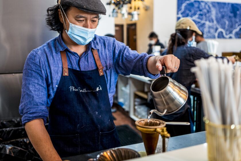 GARDEN GROVE, CA - NOVEMBER 02: Viet Do making coffee at Phin Smith on Tuesday, Nov. 2, 2021 in Garden Grove, CA. (Francine Orr / Los Angeles Times)