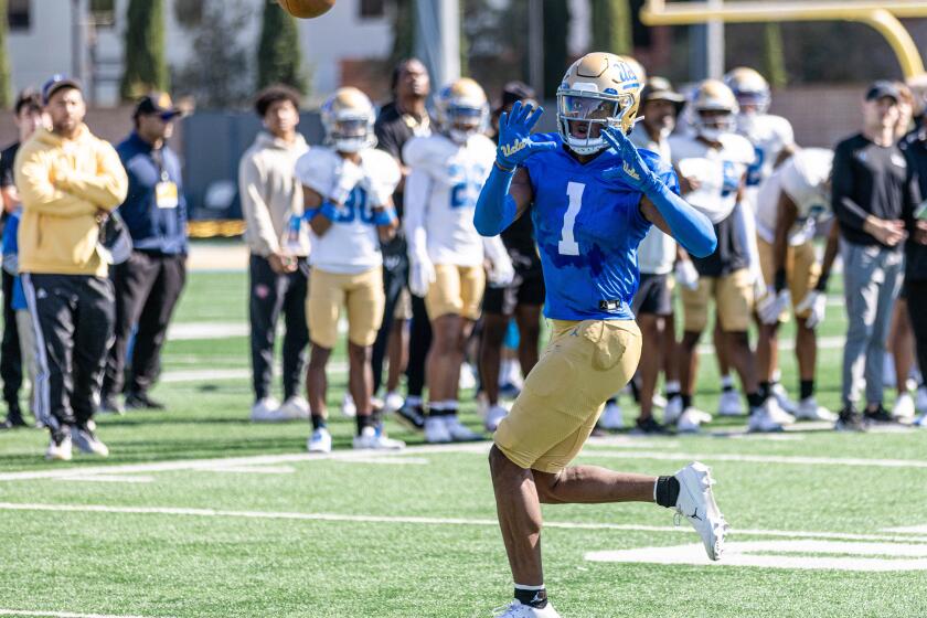 J. Michael Sturdivant raises his hands and watches the ball thrown toward him during a 2023 UCLA spring football practice.