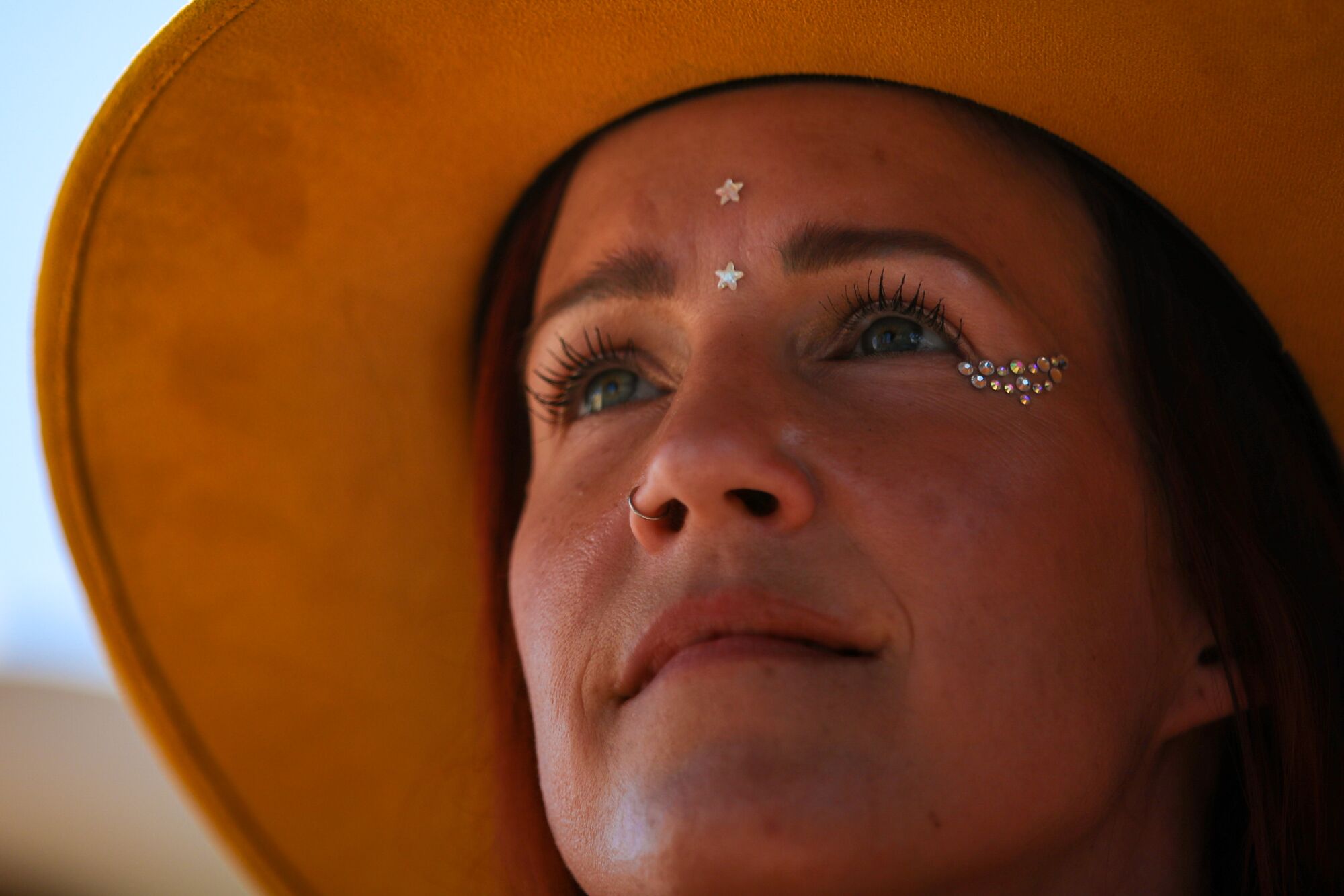 A close-up of a rapt woman in a hat.