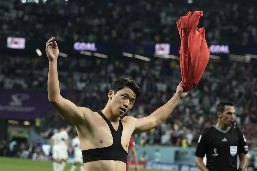 South Korea's Hwang Hee-chan celebrates after scoring his side's 2nd goal during the World Cup group H soccer match between South Korea and Portugal, at the Education City Stadium in Al Rayyan , Qatar, Friday, Dec. 2, 2022. (AP Photo/Hassan Ammar)