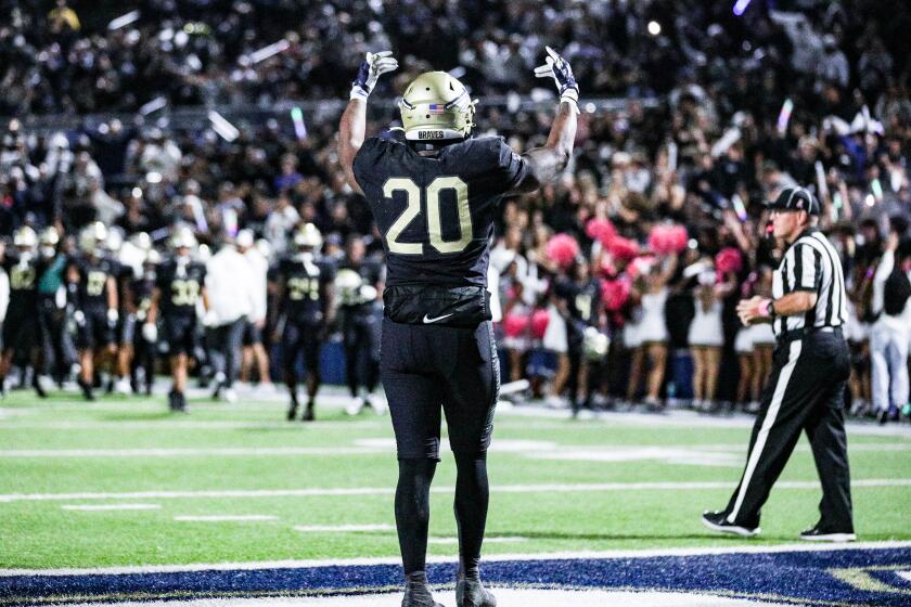 Cameron Jones of St. John Bosco faces toward the crowd after his first-quarter touchdown against Mater Dei.